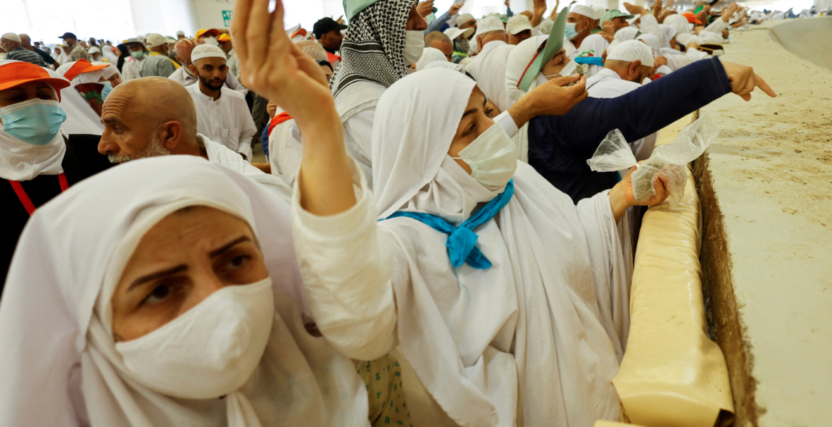 Muslim pilgrims cast their stones at a pillar symbolising the stoning of satan during the annual haj pilgrimage in mina